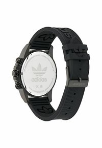 Orologio sportivo nero con retro in acciaio inossidabile, cinturino in gomma con logo in rilievo, tre pulsanti e design della cassa rotonda.