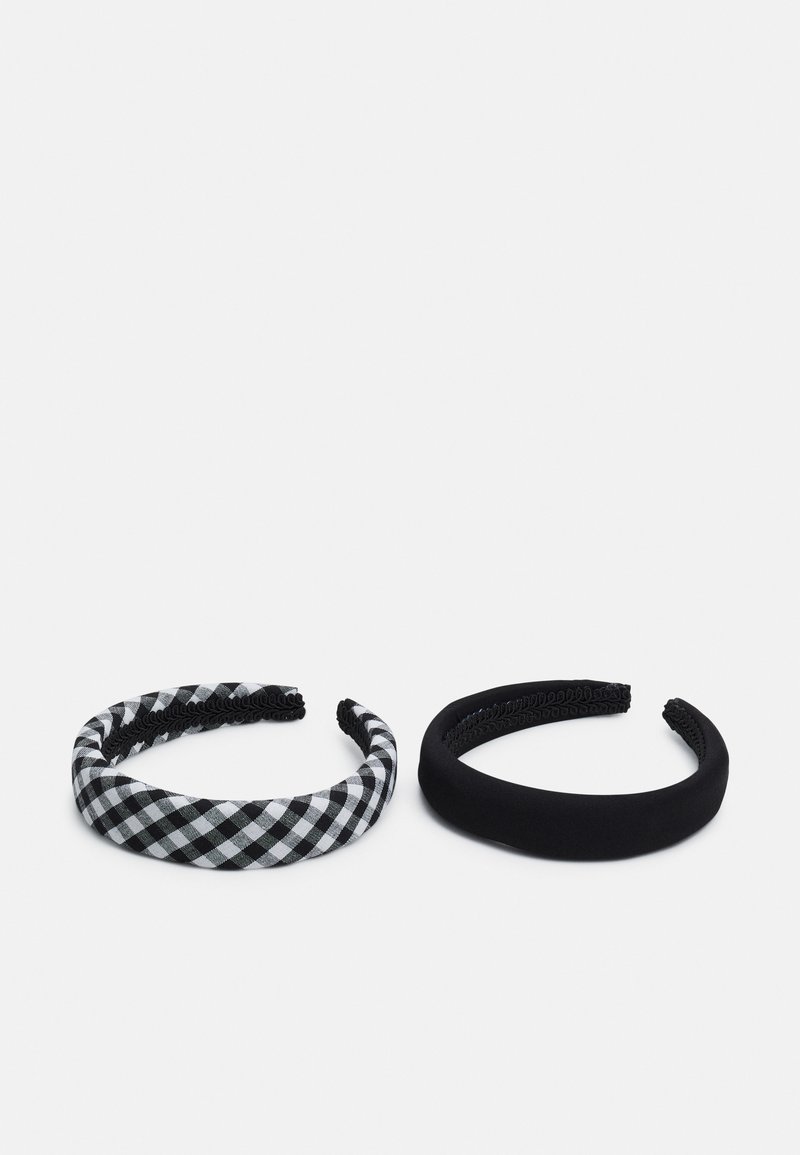 Two hairbands: left features a black and white checkered pattern, while the right is solid black with a smooth, textured finish.
