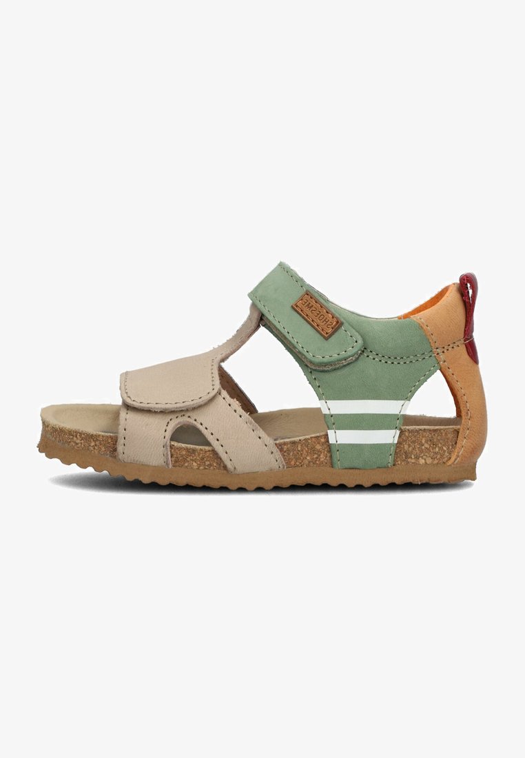 Children's sandal made of beige leather with a green and orange accent. Features a Velcro strap, cork sole, and white stripes on the side.