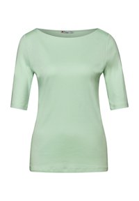 Top verde chiaro a maniche corte con un ampio collo rotondo. Realizzato in tessuto morbido e liscio con una silhouette aderente. Senza fantasie né dettagli.