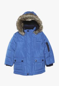 Sininen pehmustettu talvitakki, jossa on turkispäällysteinen huppu, etupainikkeelliset taskut ja vetoketjullinen hiha-tasku, suunniteltu kylmälle säälle.