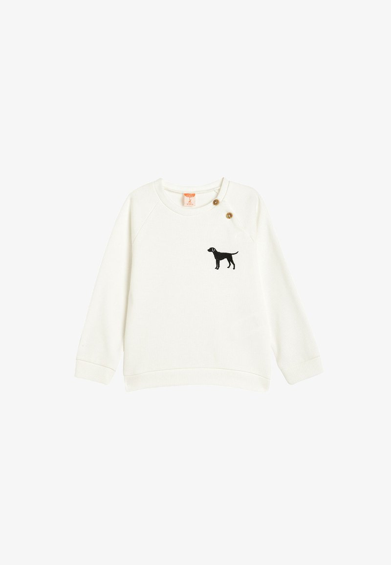 Sweatshirt bianco con maniche lunghe, texture a coste, caratterizzato da un ricamo di silhouette di cane nero sul lato sinistro del petto e dettagli con bottoni in ottone.