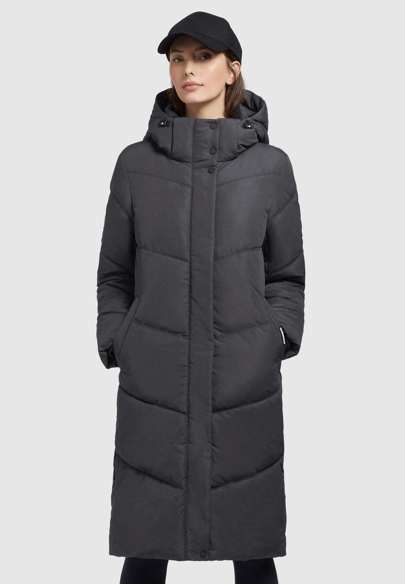 Long puffer coat in dark gray, featuring a hood, side pockets, and quilted design with overlapping panels. Smooth fabric texture.