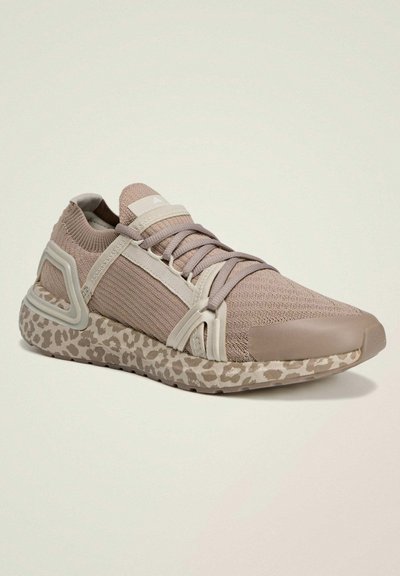 Sport shoes featuring a lightweight, taupe mesh upper, contrasting cream accents, and a patterned beige sole with a leopard print design.