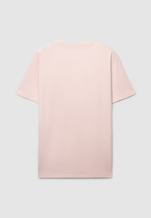T-shirt rosa chiaro a maniche corte realizzata in cotone morbido. Design classico con scollo rotondo senza motivi o decorazioni visibili.