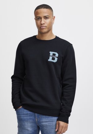 Zwarte sweatshirt van een katoenmix met een ronde hals, ribgebreide manchetten en een lichtblauw logo met een 'D' op de borst. Draag met blauwe jeans.