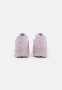 Light pink athletic shoes with rounded heels, textured mesh panels, and a subtle logo detail. Smooth finish and cushioned interior for comfort.