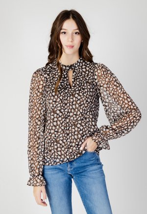 Blusa leggera e trasparente con scollatura rotonda e dettaglio a oblò. Presenta un motivo astratto marrone e bianco, polsini arricciati e maniche lunghe.