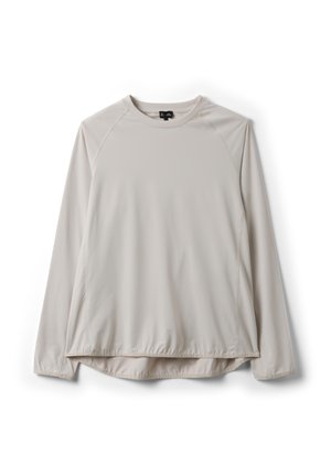 Camiseta de manga larga color beige claro con cuello redondo y mangas raglán, con un dobladillo ligeramente fruncido, mostrada extendida sobre un fondo blanco.