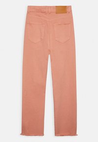 Calças de ganga cor-de-rosa com um corte reto, apresentando uma bainha desfiada, dois bolsos traseiros e um retângulo de couro na cinta.