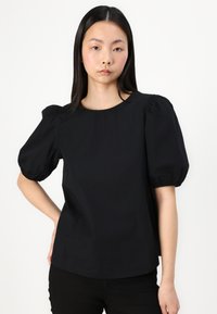 Black puff-sleeve top made of cotton, featuring a round neckline and a relaxed fit. The sleeves are gathered at the hem.