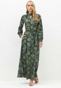 Groene bloemen midi-jurk met lange mouwen, een sleutelgat decolleté, een ceintuur in de taille en zijzakken, gemaakt van een soepele stof.