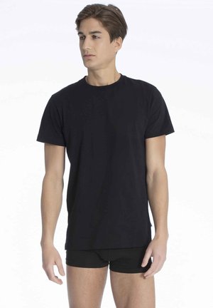 Schwarzes Baumwoll-T-Shirt mit Rundhalsausschnitt, kurzen Ärmeln, lockerer Passform, glatter Textur, getragen mit schwarzen Shorts und zeigt ein einfaches, klassisches Design.
