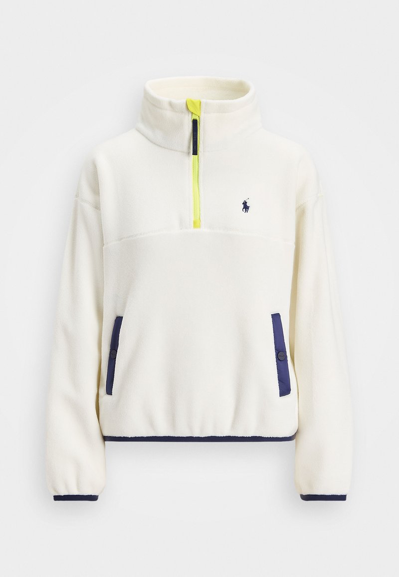 Valge fleece pullover, millel on pool tõmblukk ees, tumesinised aktsendid taskutel ja hemil, ning erksaw kollane tõmblukukäepide. Siseb väike logo rindkere kohal.