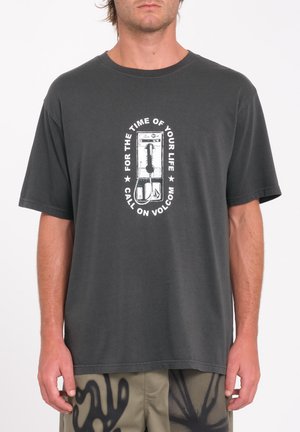 T-shirt in cotone grigio con maniche corte. Al centro presenta una grafica bianca di uno skateboard e testo, scollatura rotonda, vestibilità casual.