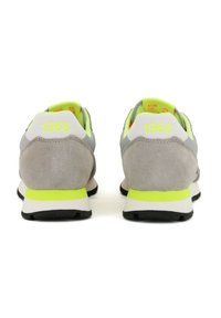 Scarpe da corsa in suede grigio con dettagli verde neon, dotate di un tallone bianco e "1968" stampato sul retro. Leggere con una suola nera.