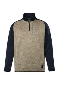 Pull-over en polaire avec une demi-fermeture éclair. Corps beige avec des manches raglan bleu marine. Comprend une poche poitrine zippée et un tissu texturé.