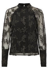 Blouse noire à manches longues avec un col haut, en tissu transparent et ornée de perles dans des motifs floraux. Détail en forme de trou de serrure au dos.
