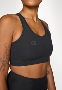 Champion SOFT TOUCH BRA LIGHT SUPPORT WITH LARGE LOGO - Sport-bh met light support - black