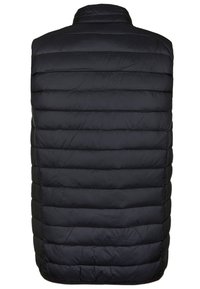 Chaleco negro acolchado, con secciones acanaladas horizontales. Cuello alto, material ligero, con una textura suave y sin herrajes visibles.