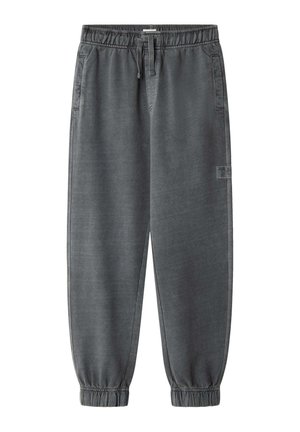 Pantaloni della tuta grigi con vita elasticizzata, cordino regolabile, tasche laterali e polsini elasticizzati alle caviglie. Tessuto dalla superficie liscia.