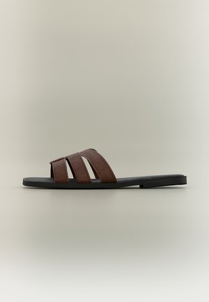 Flat black slide sandal with three wide brown straps across the top, displayed on a neutral gray background.