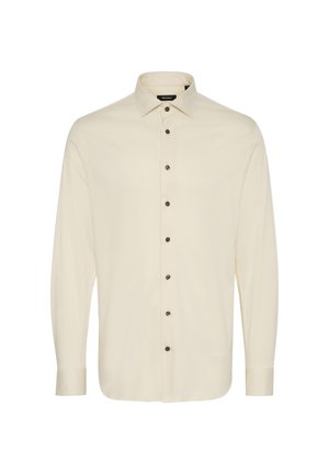 Hosszú ujjú gombos ing krémszínű anyagból, hegyes gallérral, sötét gombokkal és sima textúrával. Alkalmas hétköznapi vagy elegáns viseletre.