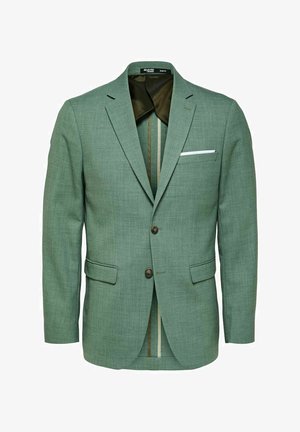 Zelený texturovaný blazer se dvěma předními kapsami, dvěma knoflíky a bílým kapesníčkem. Uvnitř lemovaný kontrastním vzorem.