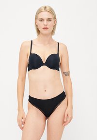 Black padded bra with adjustable straps and matching black hipster panties featuring lace trim. Both items are made of smooth, stretchy fabric.