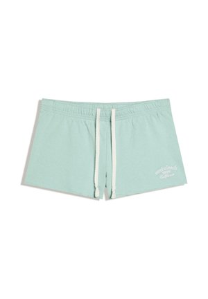 Short bleu clair à cordon avec taille élastique et texte blanc « Venice beach 1985 California » sur la partie inférieure de la jambe droite.