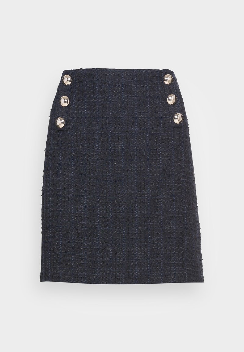 Jupe en tweed bleu marine à taille haute avec six boutons métalliques ronds, trois de chaque côté près de la ceinture.
