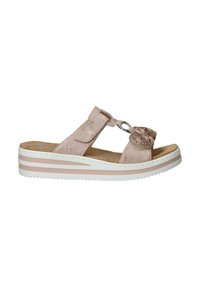Pink suede sandal with two circular accents, adjustable strap, white and pink layered sole, textured insole, open-toe design.
