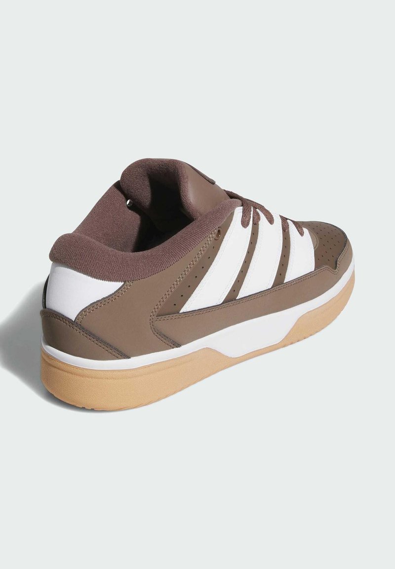 Brown athletic shoe with white stripes. Features a smooth synthetic upper, padded collar, and a gum rubber outsole. Perforated detailing included.