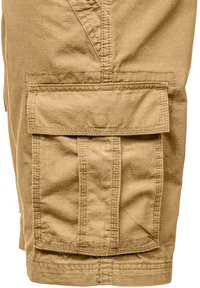 Khaki cargo shorts featuring a large, flap pocket on the leg, textured fabric with subtle lines, and reinforced stitching details.