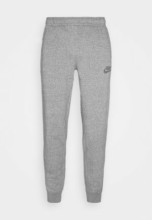 Jasnoszare spodnie dresowe Nike z elastycznym pasem i ściągaczami, z małym czarnym logo Nike na lewej udzie.