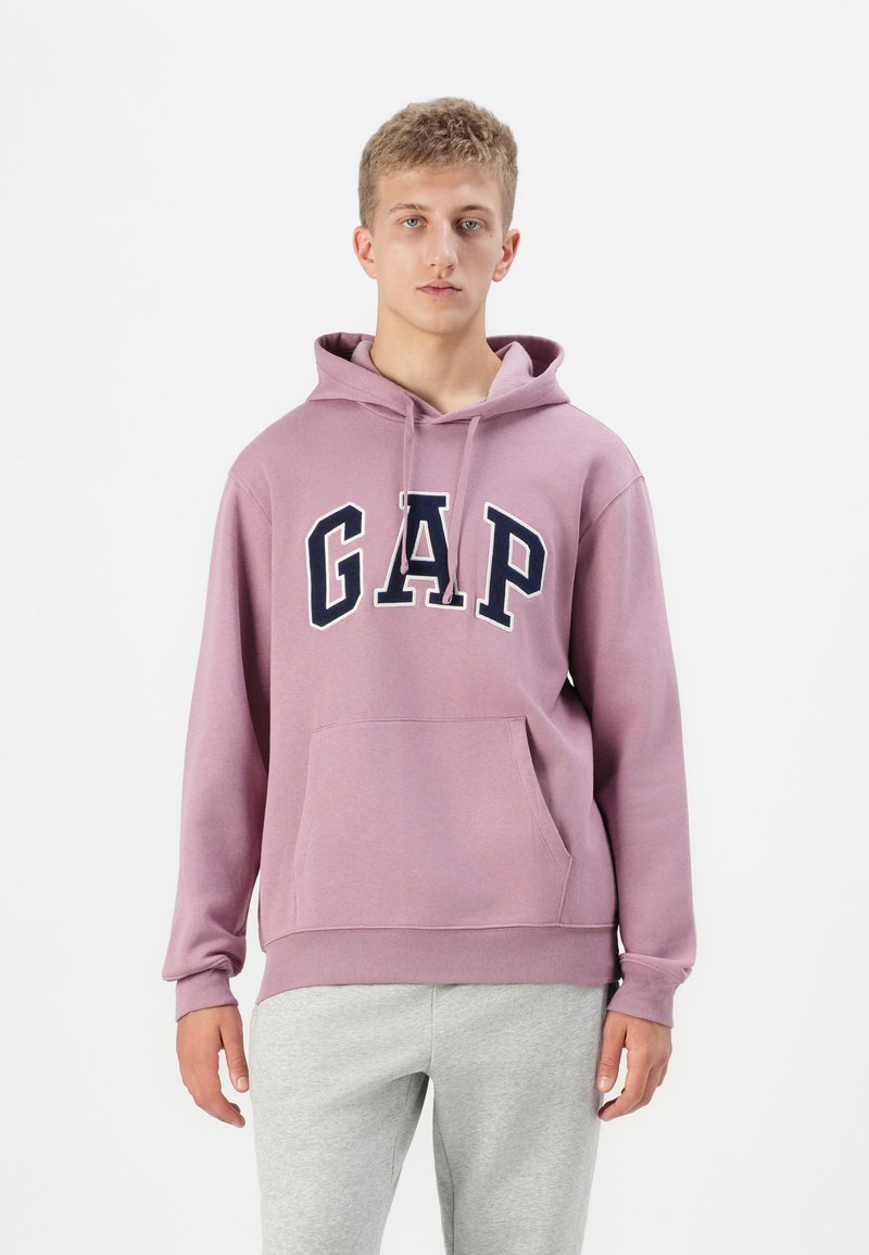 Pullover hoodie in light purple, featuring a large navy "GAP" logo. Made of cotton blend, with a front pocket and adjustable drawstring hood.