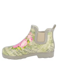 Botte de pluie Chelsea crème avec motif floral comprenant des fleurs roses, des feuilles vertes et du texte botanique. Caoutchouc texturé avec panneaux latéraux élastiques.