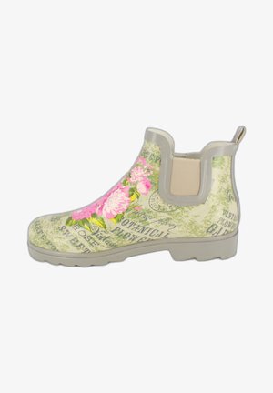 Botte de pluie Chelsea crème avec motif floral comprenant des fleurs roses, des feuilles vertes et du texte botanique. Caoutchouc texturé avec panneaux latéraux élastiques.