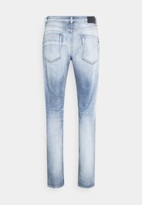 Vaaleansiniset farkut slim fit -mallilla, joissa on takataskut, haalistunut pinta ja kontrastiväriset ompeluyksityiskohdat.