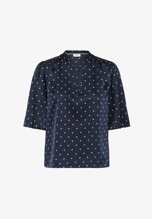 Navyblauwe blouse van een gladde stof, met witte stippen, een v-halslijn en korte, gepofte mouwen.