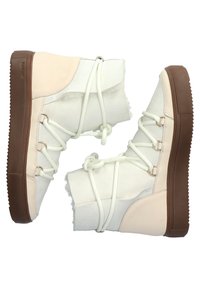 Bottes d'hiver montantes avec tissu doux blanc, accents en cuir crème, semelles en caoutchouc brun épaisses et lacets en corde blanche enroulés autour des chevilles.