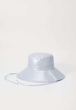 Silver bucket hat made of shiny, smooth material with a wide brim and adjustable chin strap, featuring a stitched pattern on the brim.