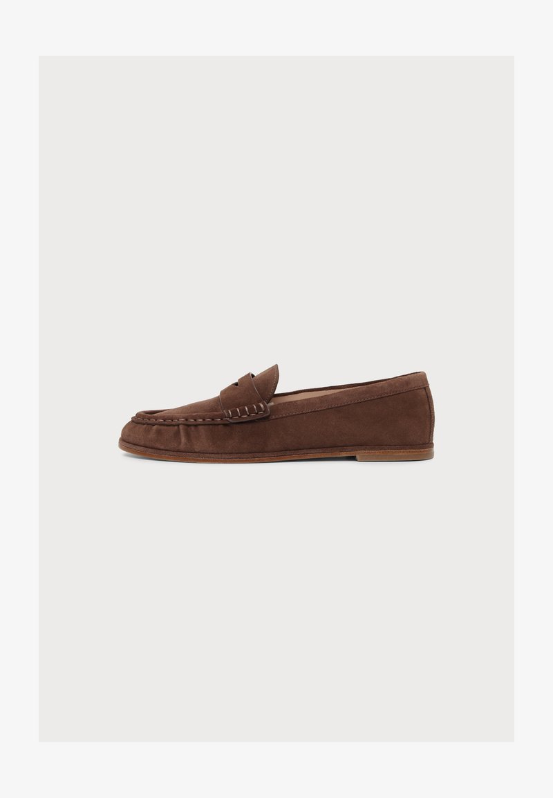 Mocassin homme en daim marron avec semelle plate et couture style mocassin sur fond clair.