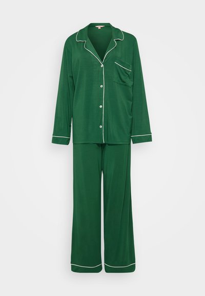 Green, long-sleeve pajama set made of soft fabric. Features white piping along the collar, buttons, pocket, and pant hems. Loose-fitting design.