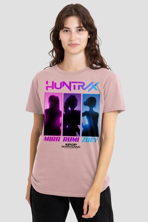 Woman wearing pink T-shirt with purple and blue silhouettes of three female characters labeled Mira, Rumi, and Zoey from K-Pop Demon Hunters.