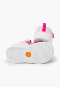 Pink children's shoes with rubber sole, white outsole and textured grip. Features pink strap and pull tab for easy wear.