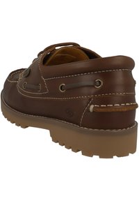 Braune Lederbootsschuhe mit niedrigem Knöcheldesign, verziert mit dekorativen Nähten, Schnürösen und einer strukturierten Gummisohle.