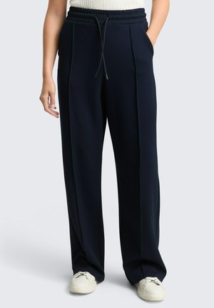 Pantaloni a gamba larga di colore blu navy con fascia elastica in vita e coulisse. Presentano due tasche frontali e un tessuto strutturato.
