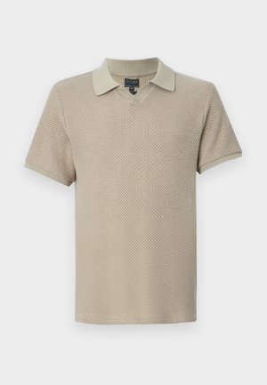 Light beige knitted polo shirt with short sleeves, featuring a v-neck design and a contrasting collar. Textured fabric with a breathable pattern.