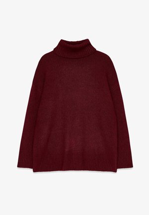 Burgundy stickad turtleneck-tröja med ribbad krage och mudd. Boxig form och mjuk textur, med sänkt axel och vid kropp.